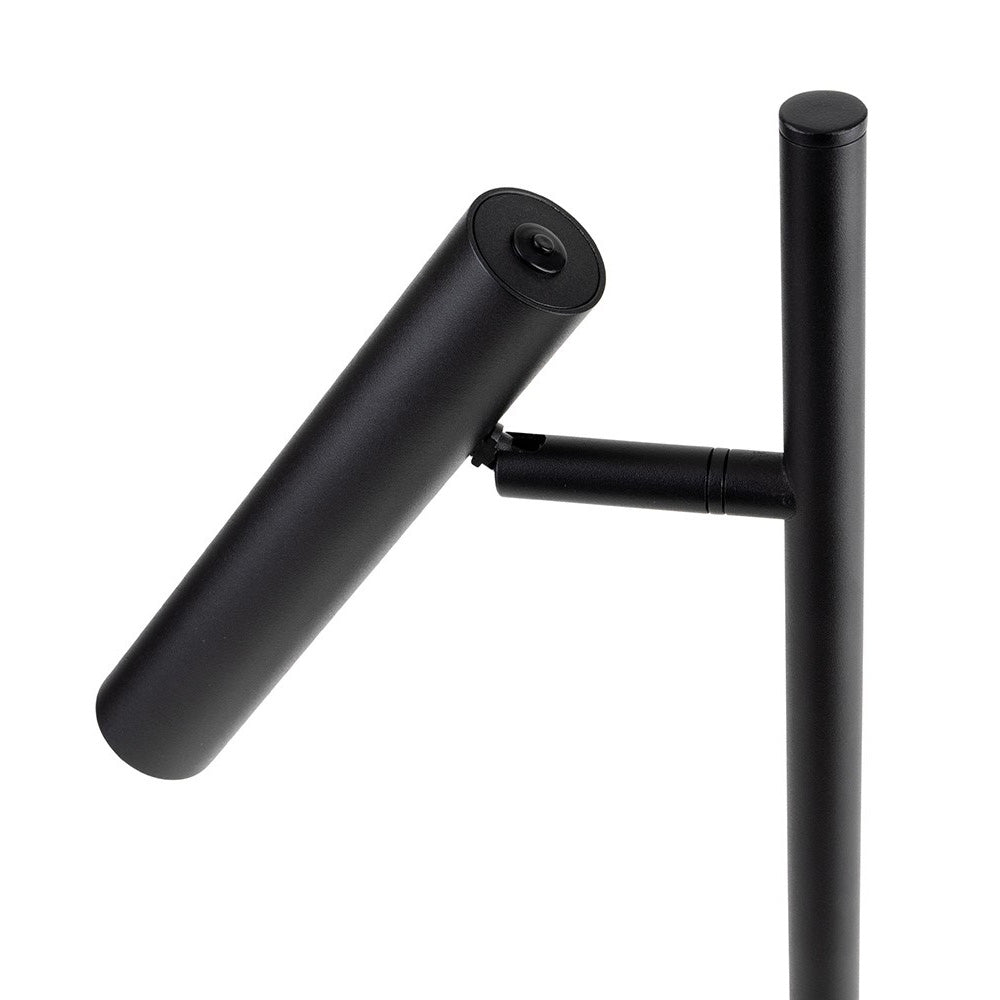 Black cylindrical light fixture attached to a vertical pole
