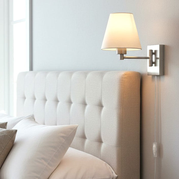 Tufted upholstered headboard with a wall-mounted swing-arm lamp