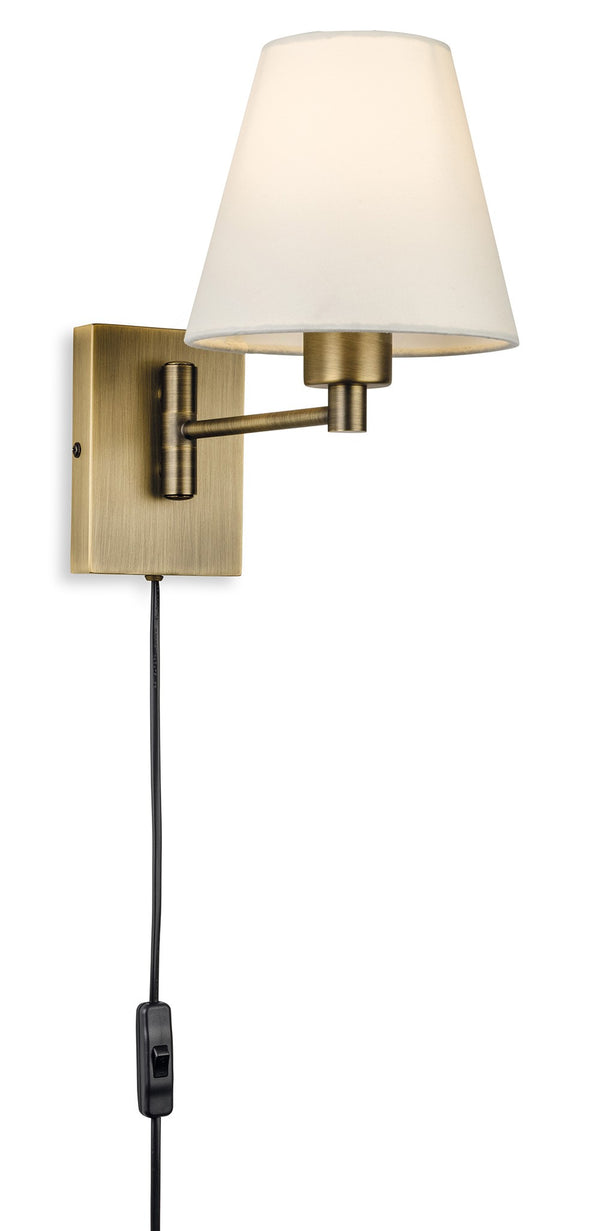 Brass wall lamp with a white conical shade and a black cord with an inline switch