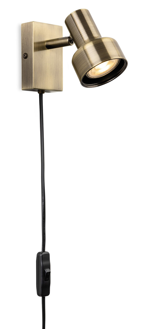 Brass wall light with an adjustable spotlight head and a black cord with an inline switch