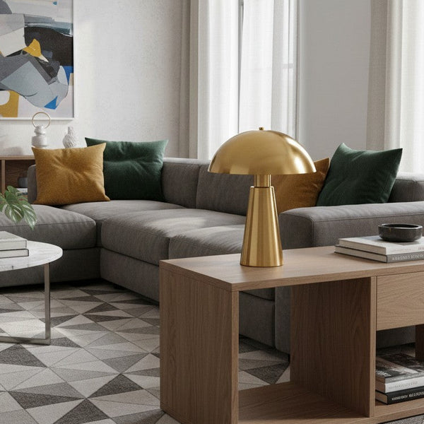 Living room with a gray sectional sofa, mustard and dark green throw pillows, and a gold mushroom lamp