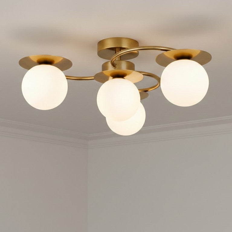 Brass ceiling light with four white globe shades