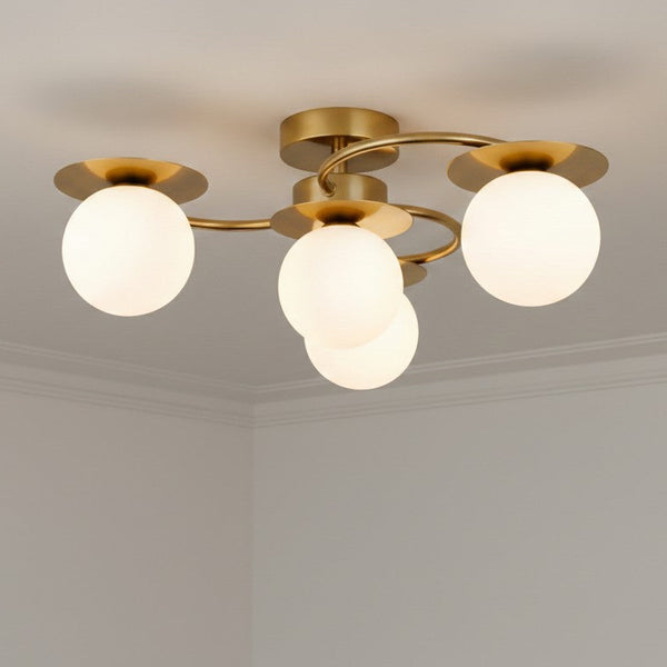 Brass ceiling light with four white globe shades
