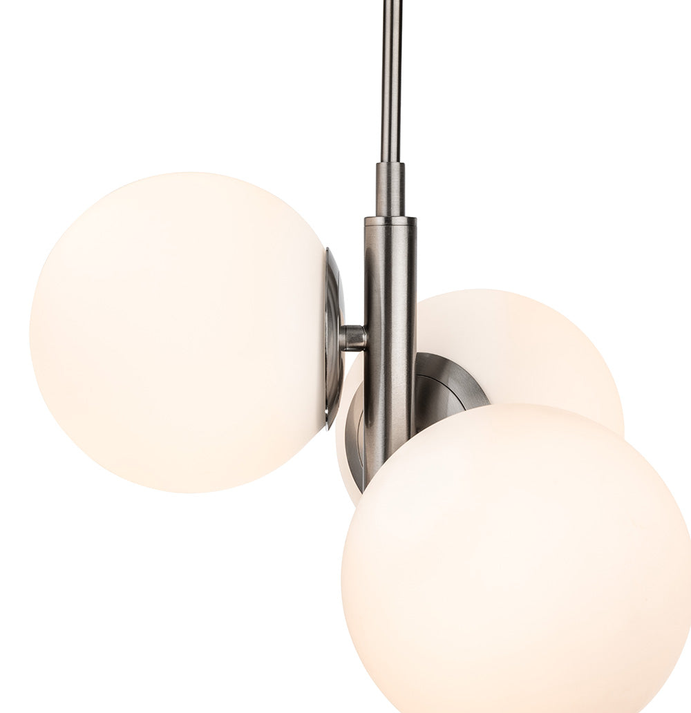 Brushed nickel pendant light with three white globe shades