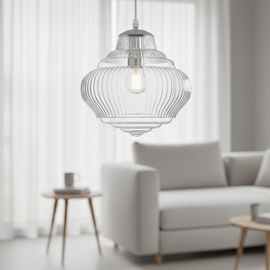 Clear glass pendant light with ribbed texture and visible bulb, hanging in a living room