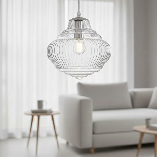 Clear glass pendant light with ribbed texture and visible bulb, hanging in a living room
