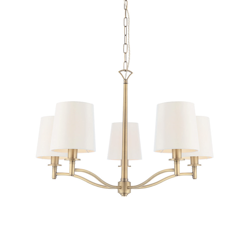 A five-light chandelier with cream shades and a gold-finished frame hangs against a white background.