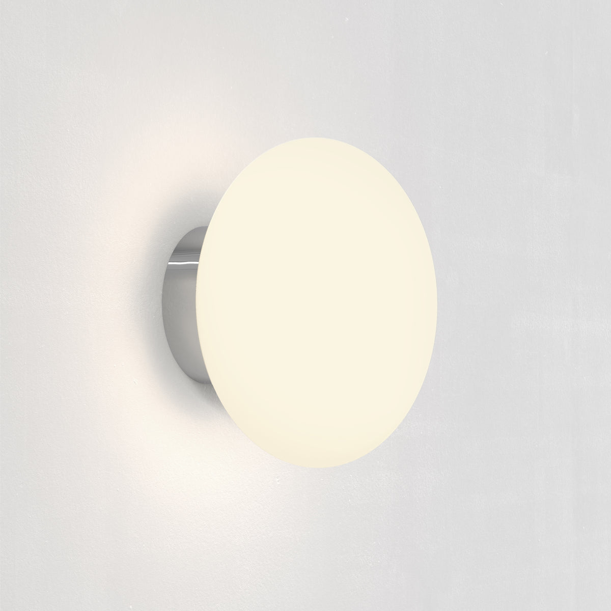Round white wall light with a chrome base