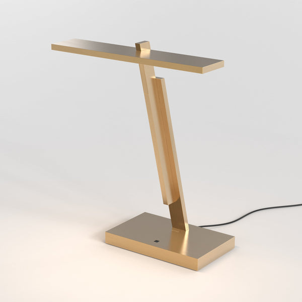 Gold desk lamp with a rectangular base and a thin, horizontal light bar