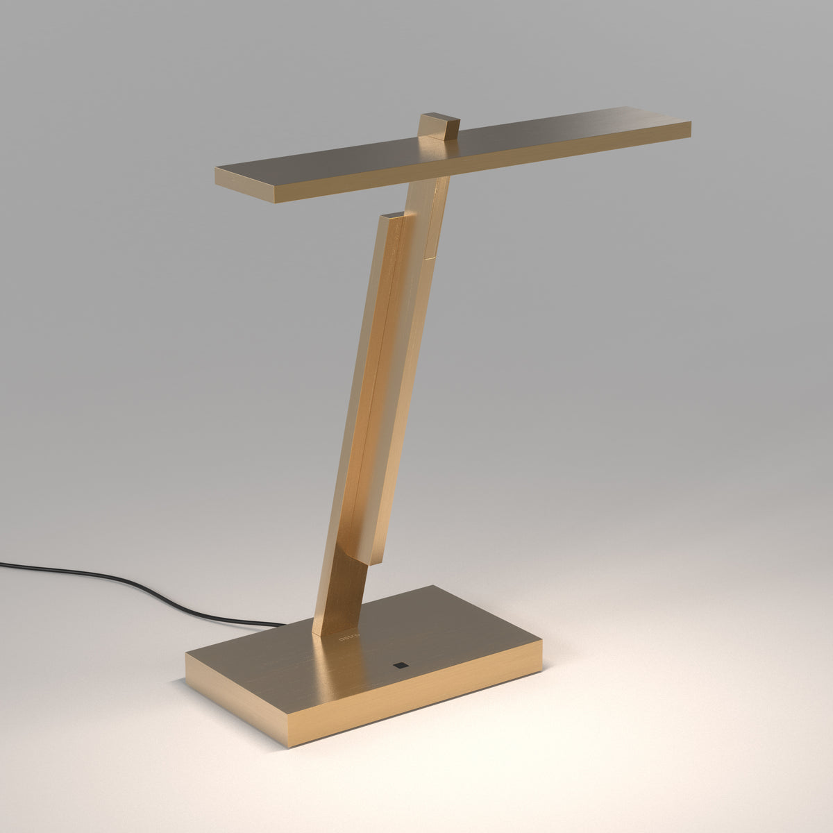 Gold desk lamp with a rectangular base and a long, flat light bar