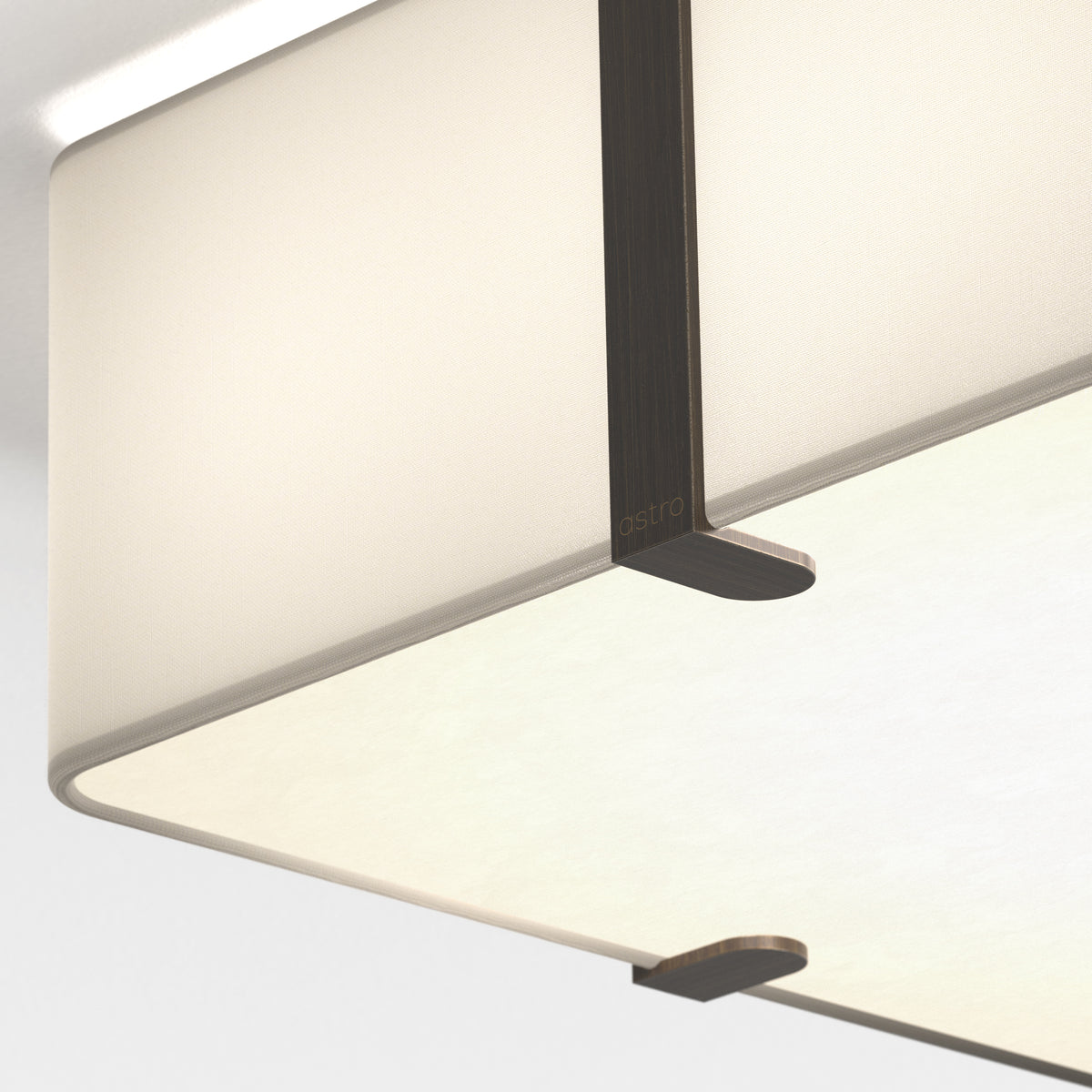 A close-up view of a rectangular ceiling light fixture with a fabric shade and dark bronze accents
