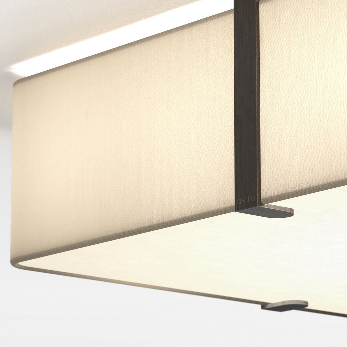 Close up of a rectangular ceiling light with a fabric shade and a dark metal frame