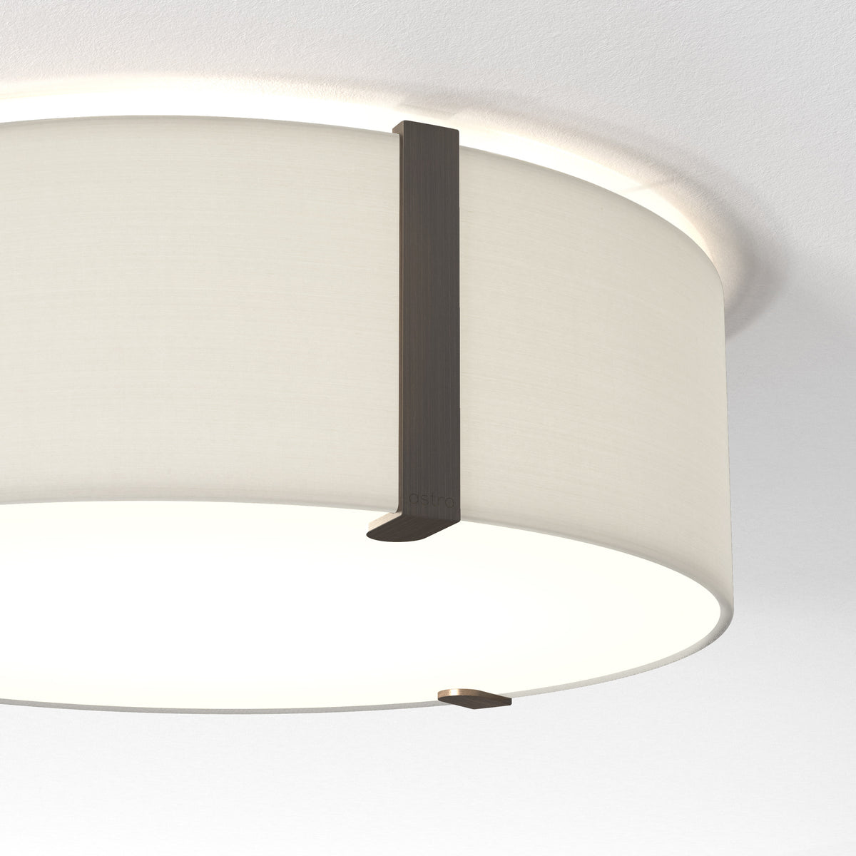 A close-up of a white ceiling light with a fabric shade and dark bronze metal accents