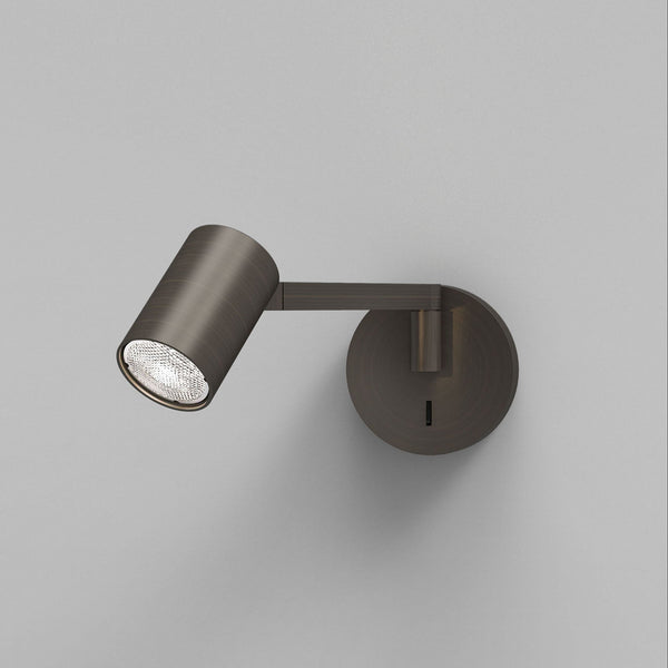 Bronze wall-mounted spotlight with a textured light bulb