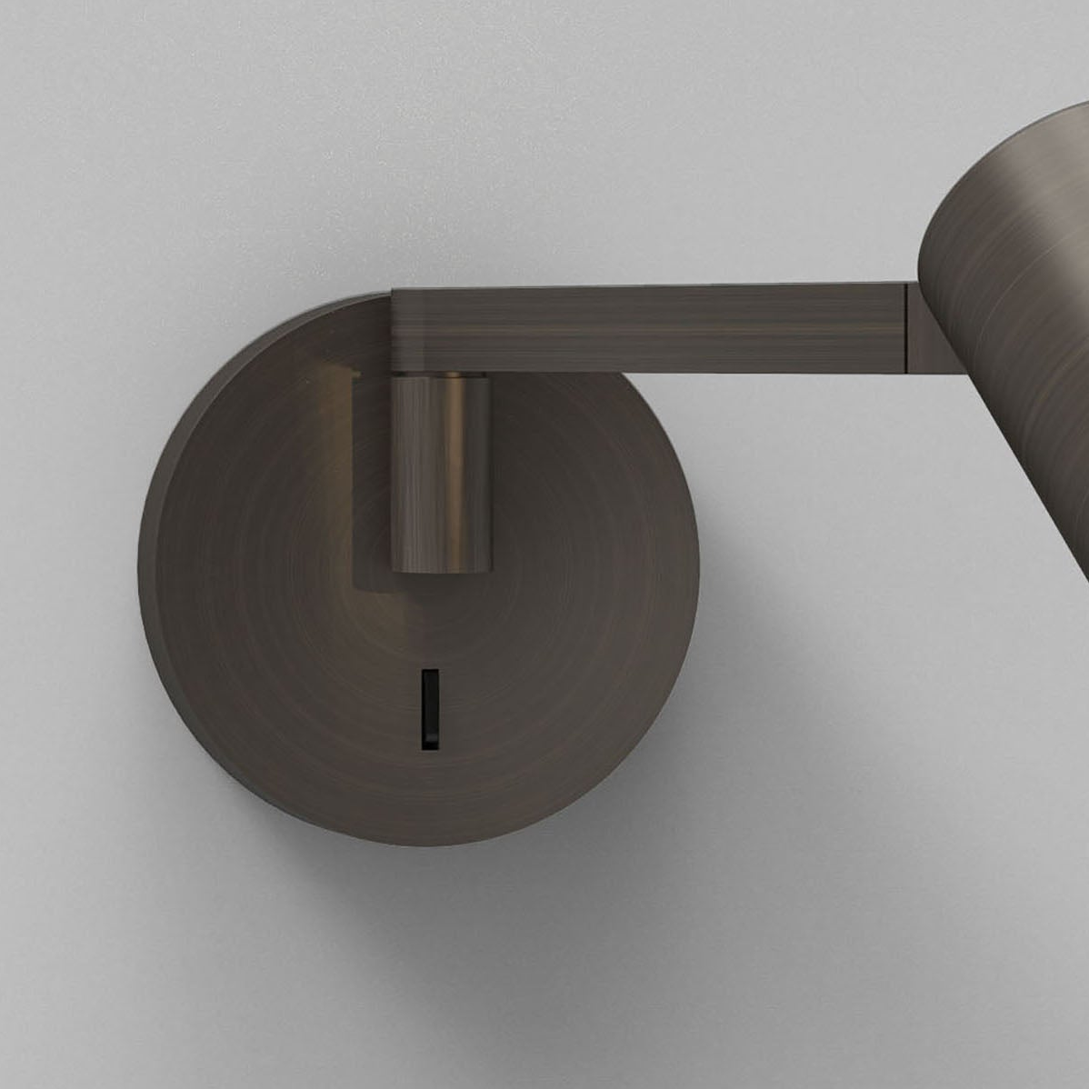Bronze wall sconce with a circular base and an adjustable arm holding a conical light fixture