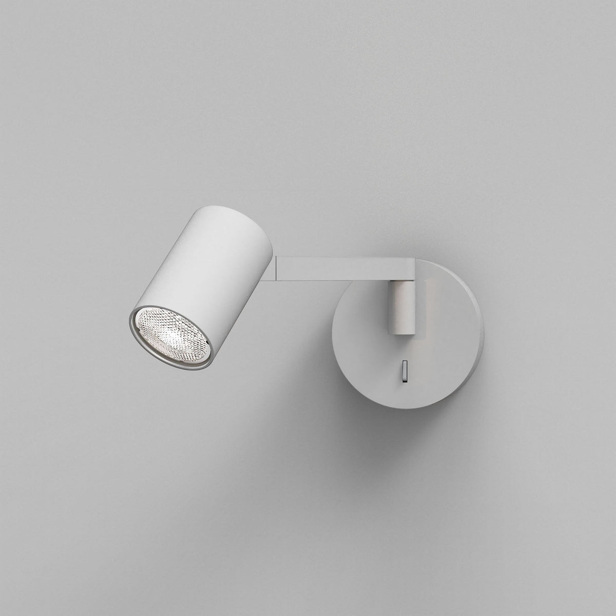 White cylindrical wall light with a textured bulb, mounted on a round base with a rectangular switch