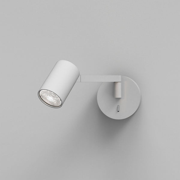 White cylindrical wall light with a textured bulb, mounted on a round base with a rectangular switch