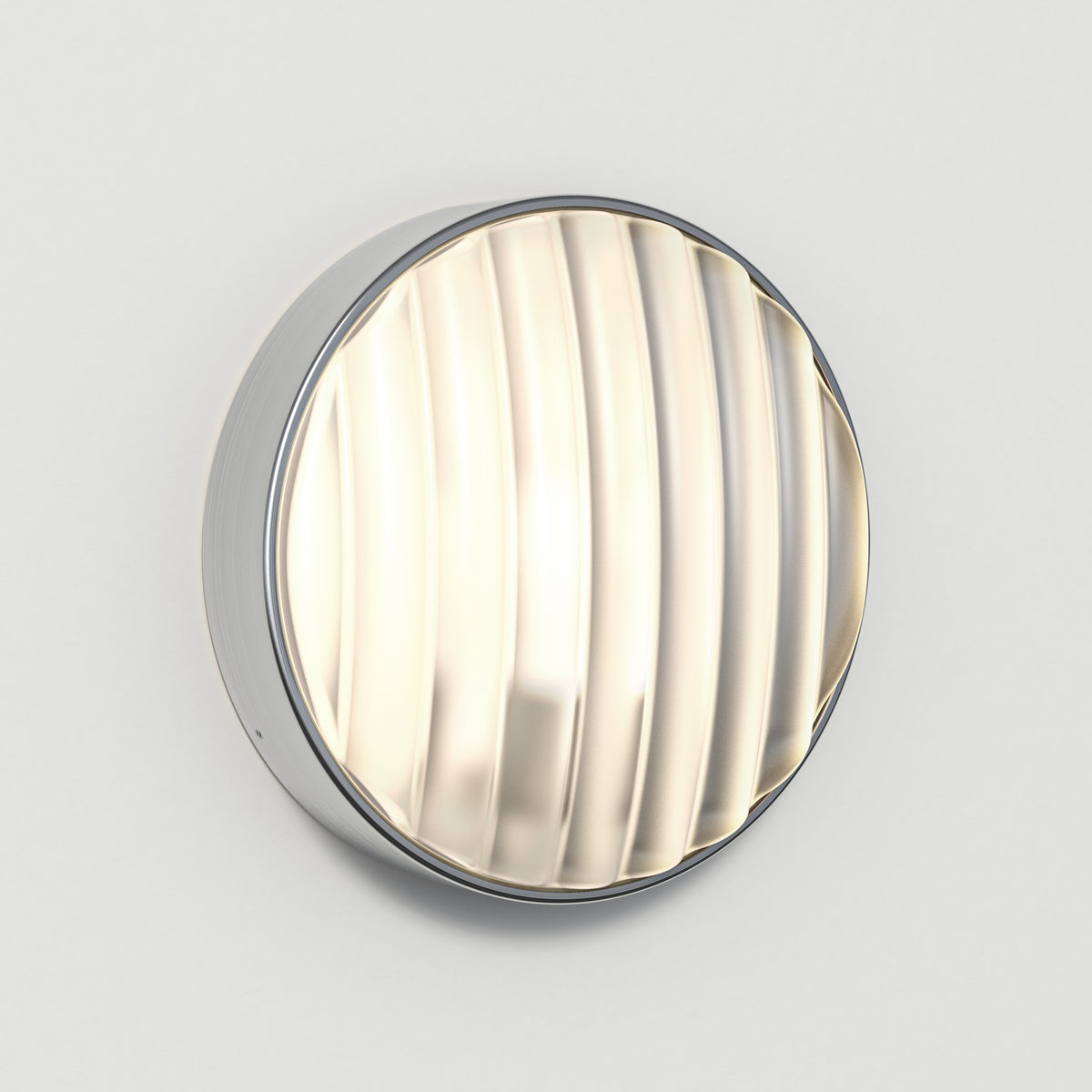 Round wall light with a brushed chrome finish and a ribbed glass diffuser