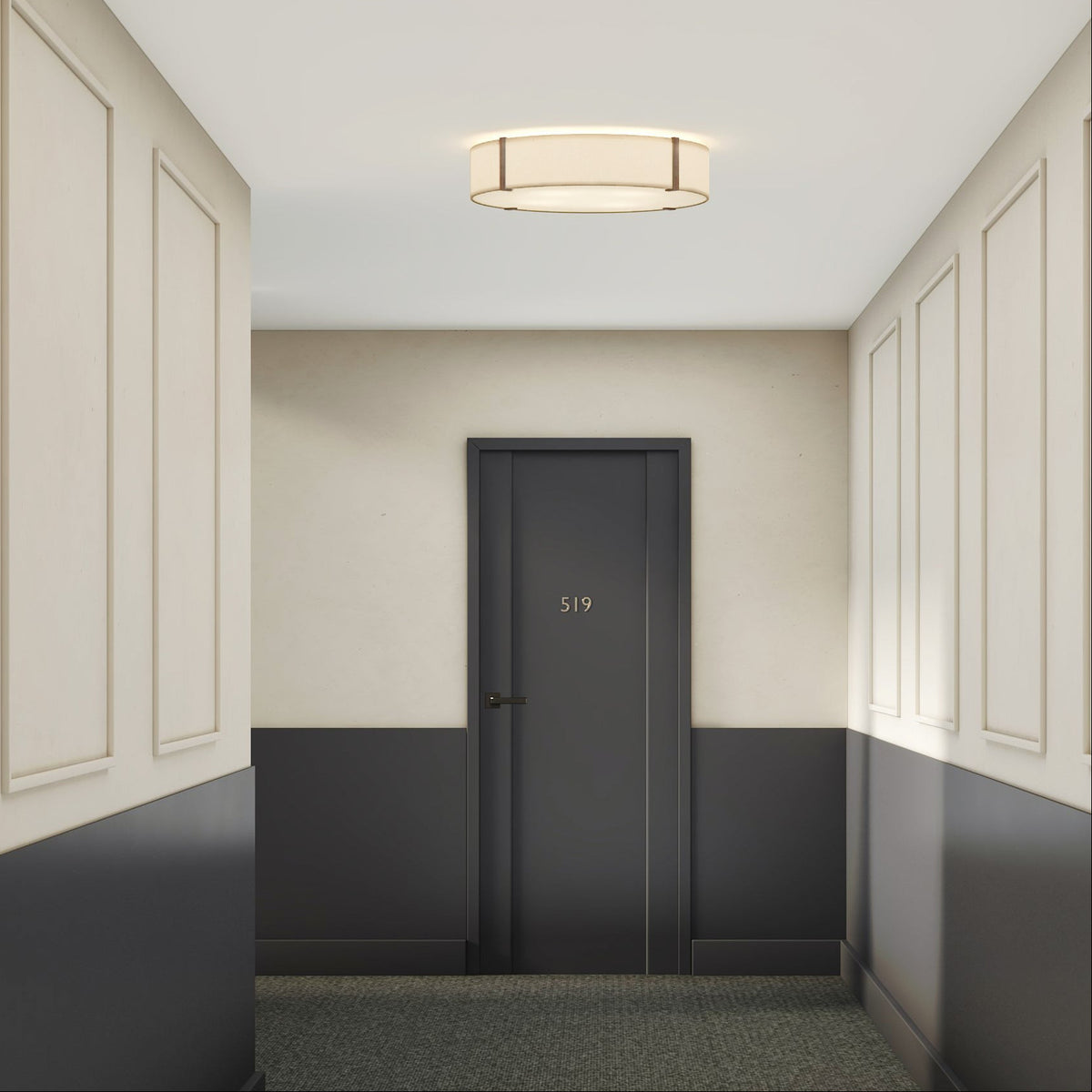 Hallway with light beige walls and dark gray wainscoting, leading to a dark gray door with the number 519