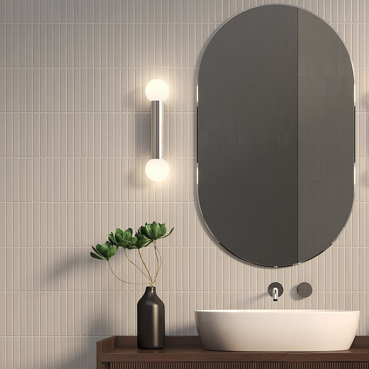 Bathroom with light grey vertical tiles, oval mirror, wall-mounted faucet, and white basin