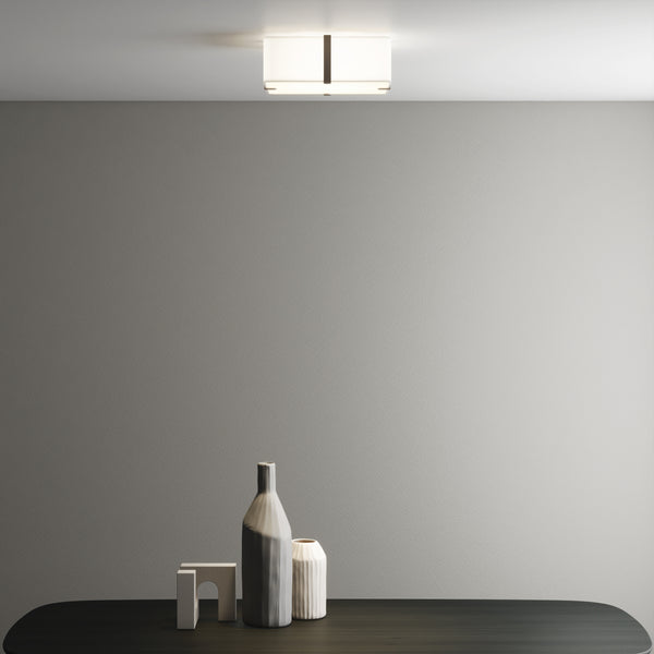A rectangular ceiling light with a white fabric shade and dark bronze accents