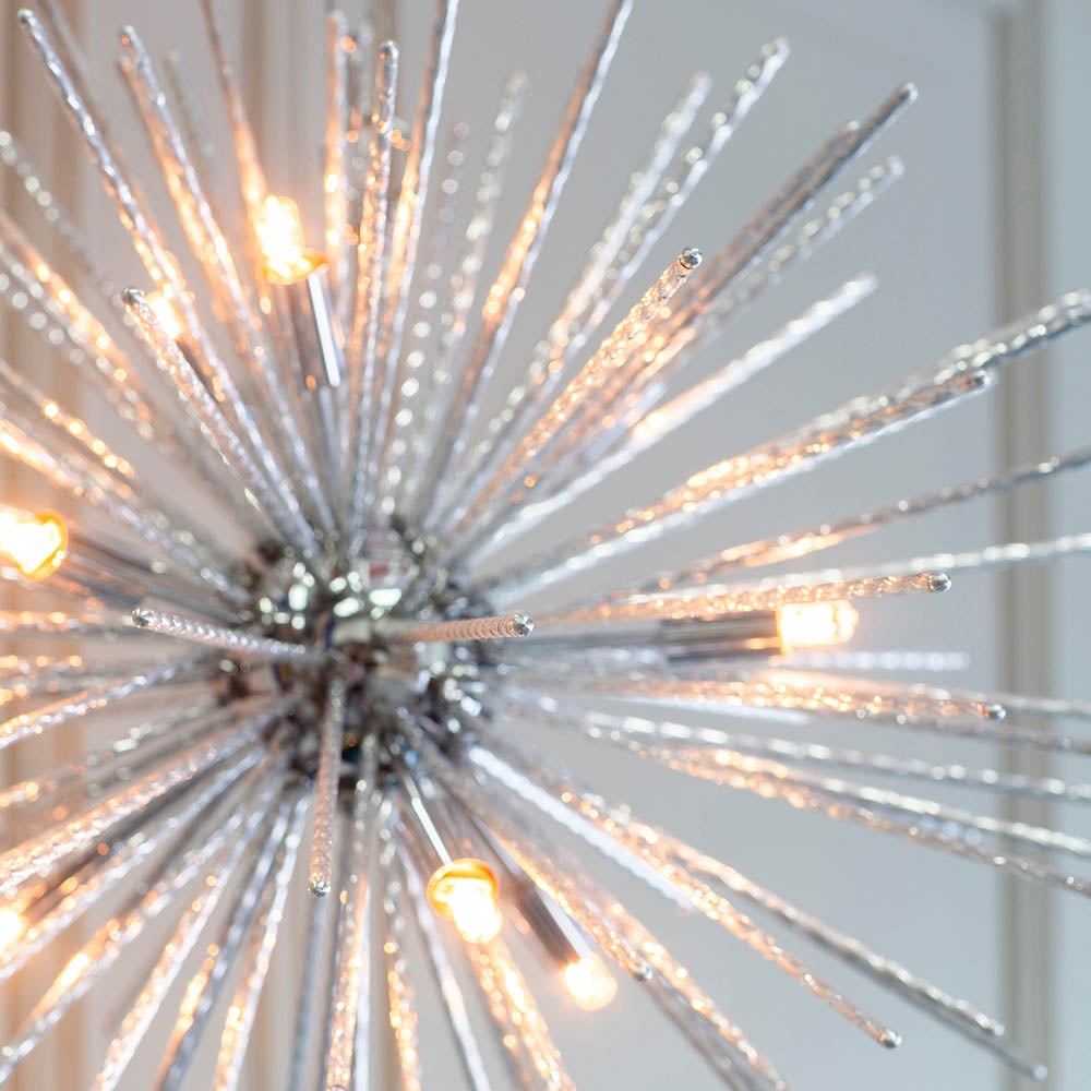 Close-up of a chrome Sputnik chandelier with clear glass rods, showing the illuminated bulbs and textured glass.