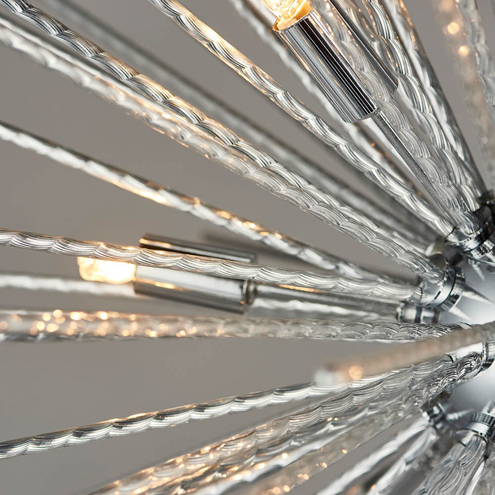 Detailed view of the chrome Sputnik chandelier's clear glass rods and glowing bulbs.