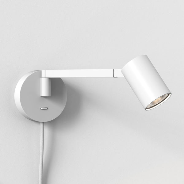 White wall-mounted spotlight with an adjustable arm and a visible lightbulb