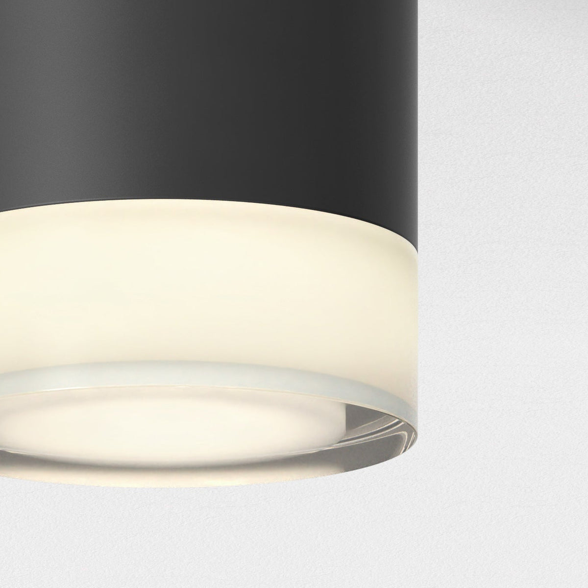 Close up of a black and white cylindrical light fixture