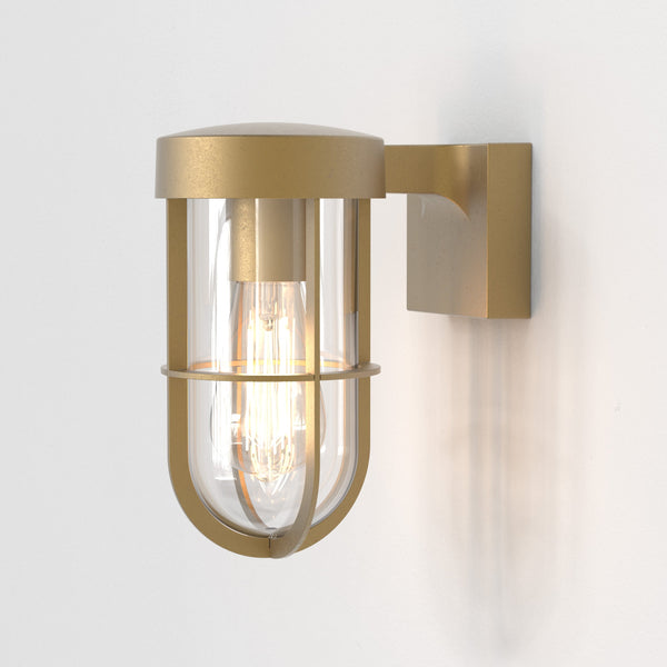 Brass outdoor wall light with clear glass and exposed bulb