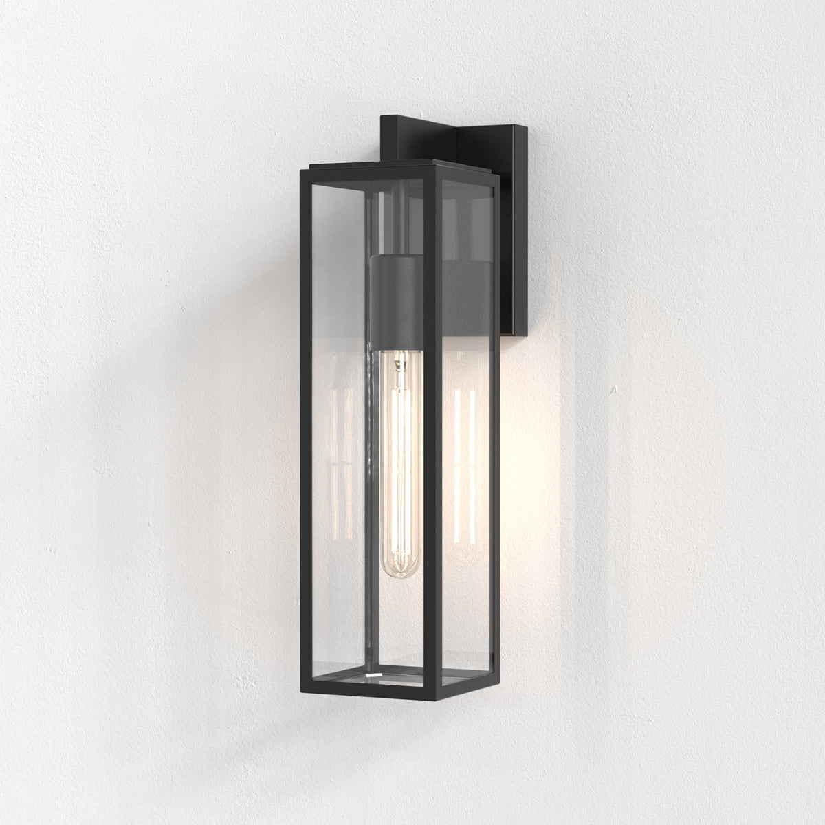 Black rectangular outdoor wall light with clear glass panels and an exposed filament bulb