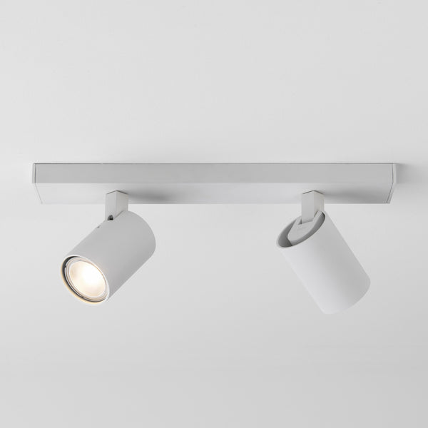 White ceiling light fixture with two adjustable spotlights, one illuminated