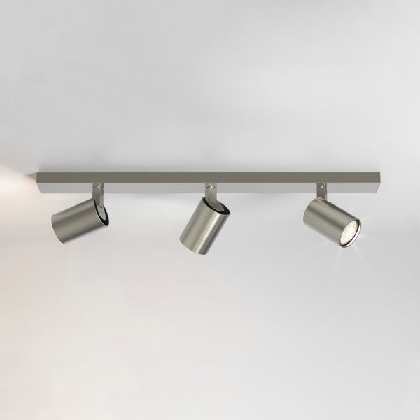 Three brushed nickel track lights on a white ceiling