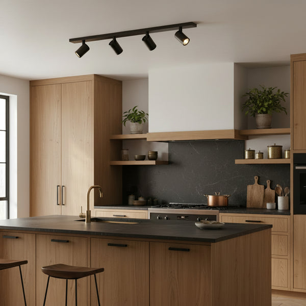 Black track lighting with four spotlights in a modern kitchen with wooden cabinets and dark countertops