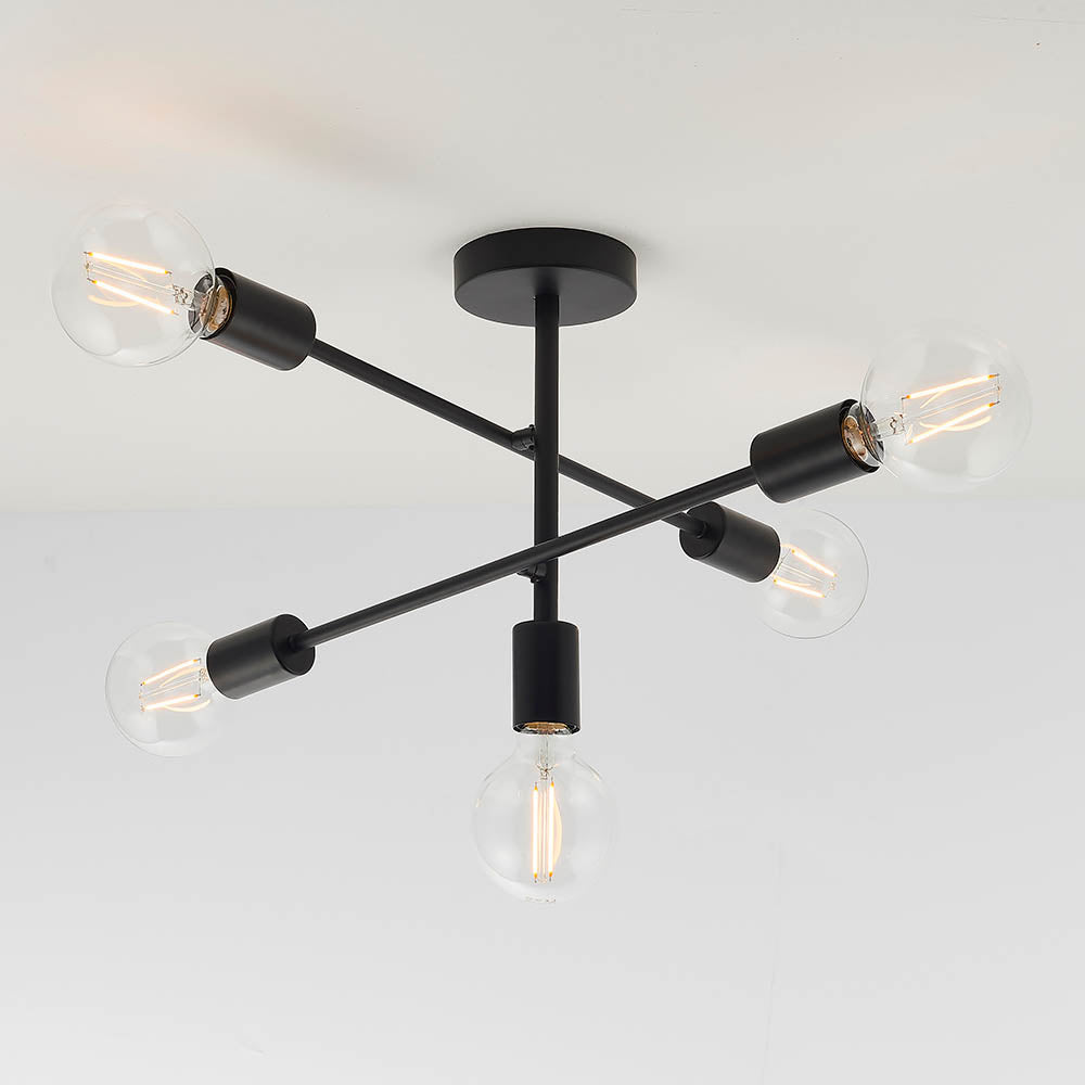 A black ceiling light with five exposed bulbs, angled downwards and outwards from a central stem.