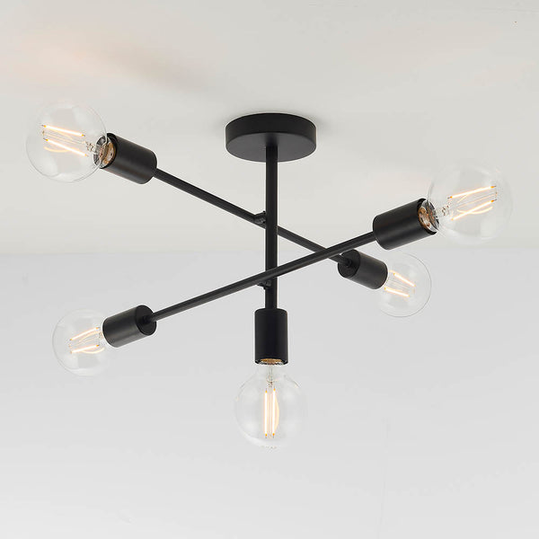 A black ceiling light with five exposed bulbs, angled downwards and outwards from a central stem.