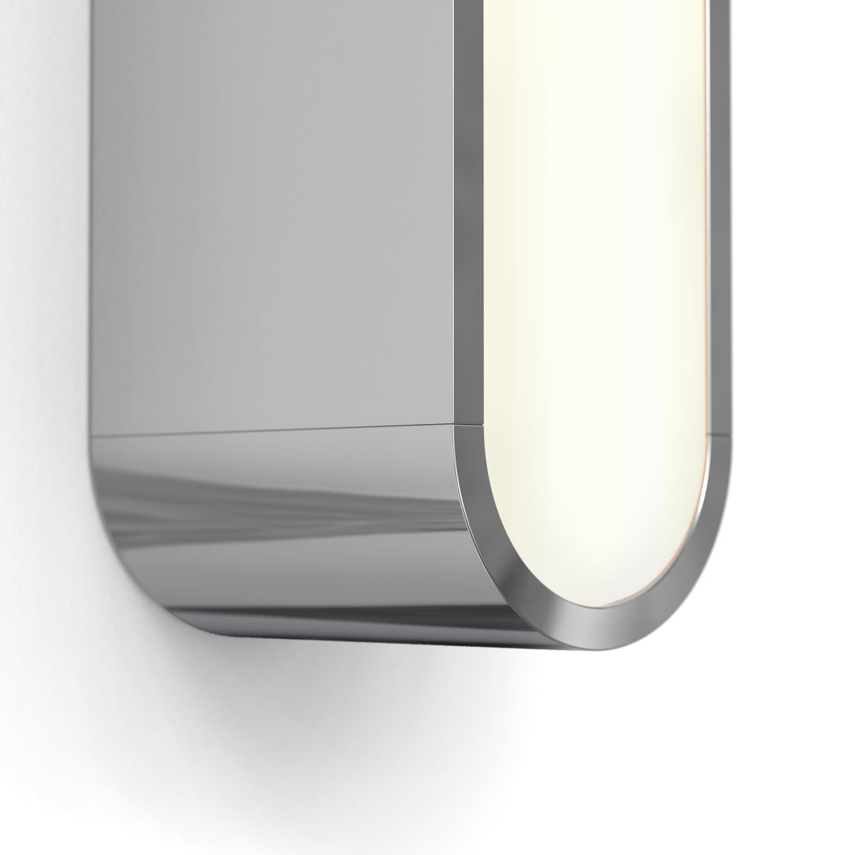 Close up of a silver wall light with a rounded illuminated edge