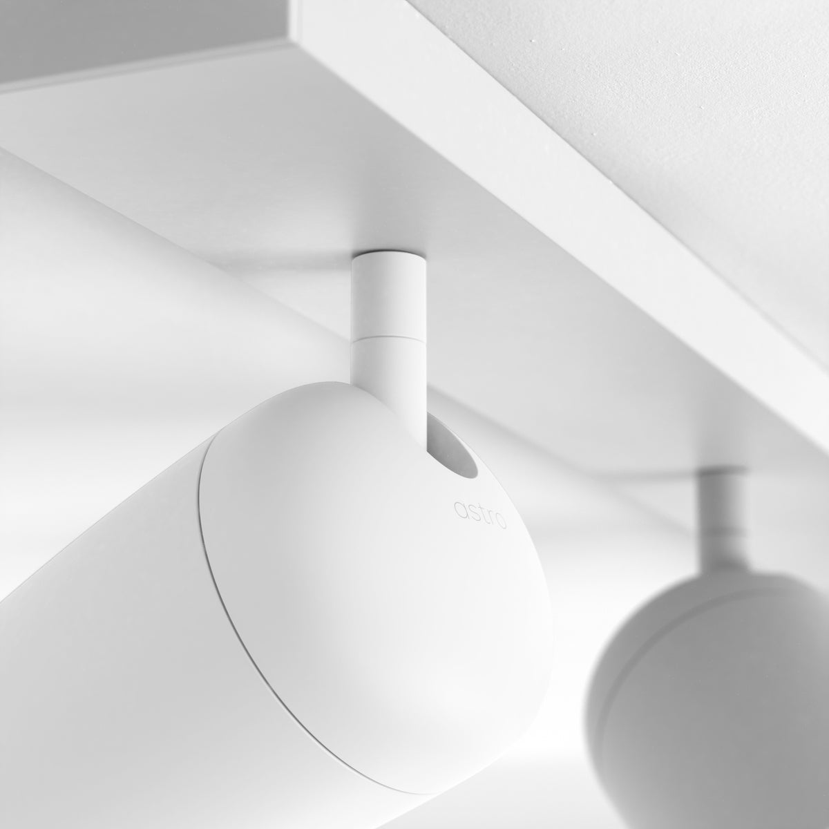 Astro branded white cylindrical ceiling light fixture