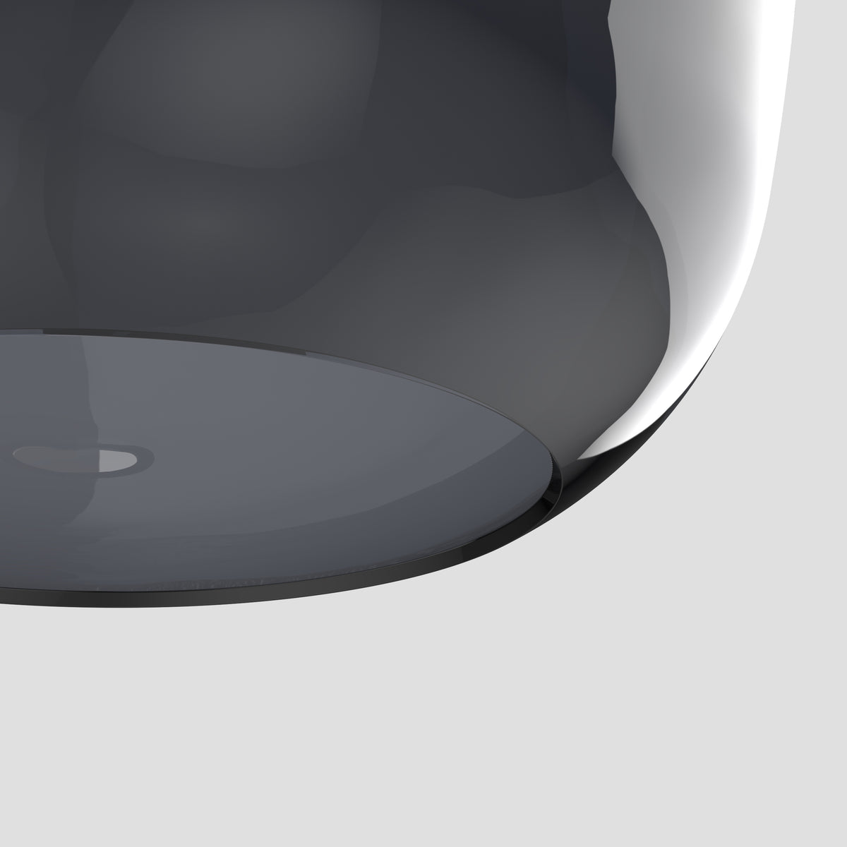 Close up of a dark grey glass dome with a black rim and a small circular opening