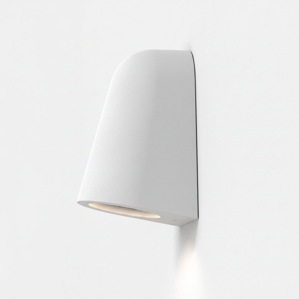 White wall-mounted light fixture with a curved top and a downward-facing light