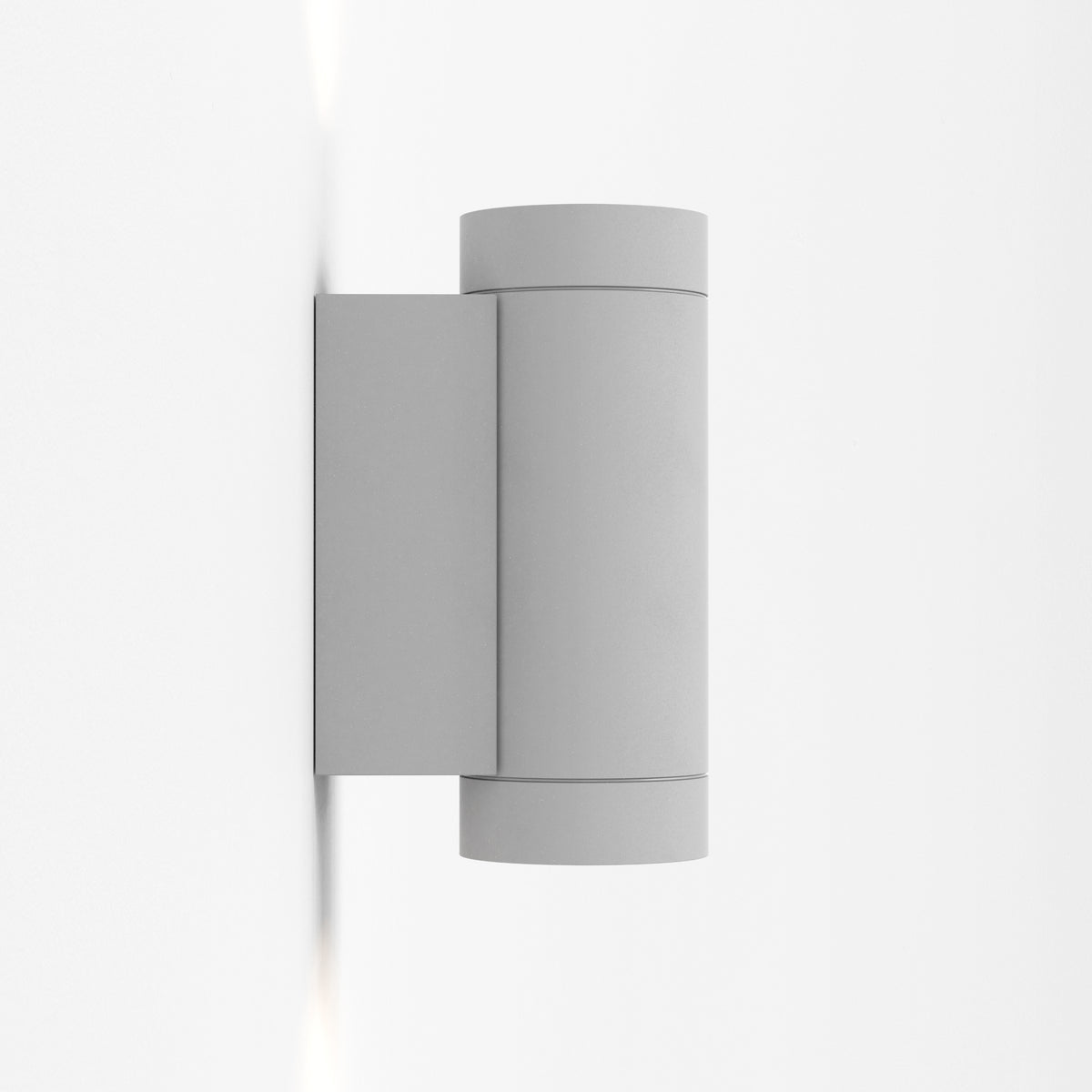 Grey cylindrical outdoor wall light with light beams shining upwards and downwards