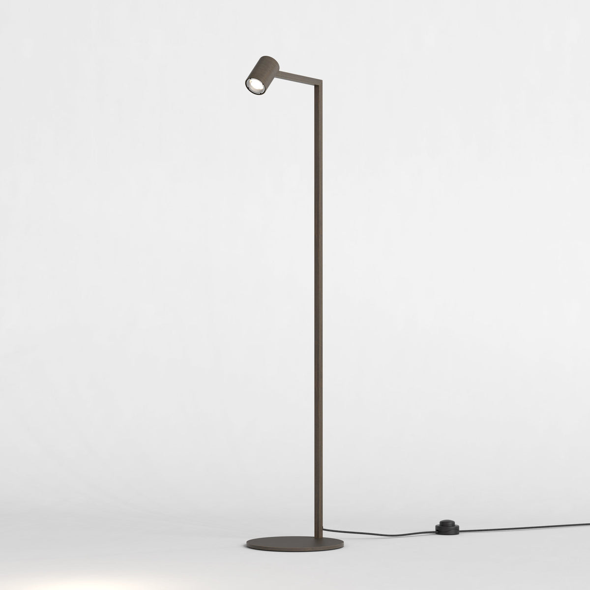 Dark grey floor lamp with a round base and a single light pointing downwards