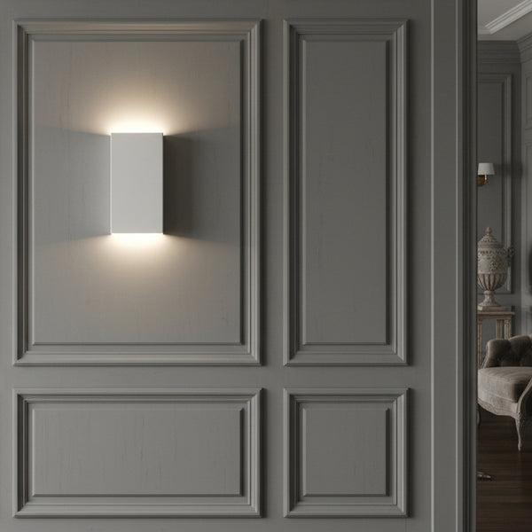 White rectangular wall light on a grey paneled wall