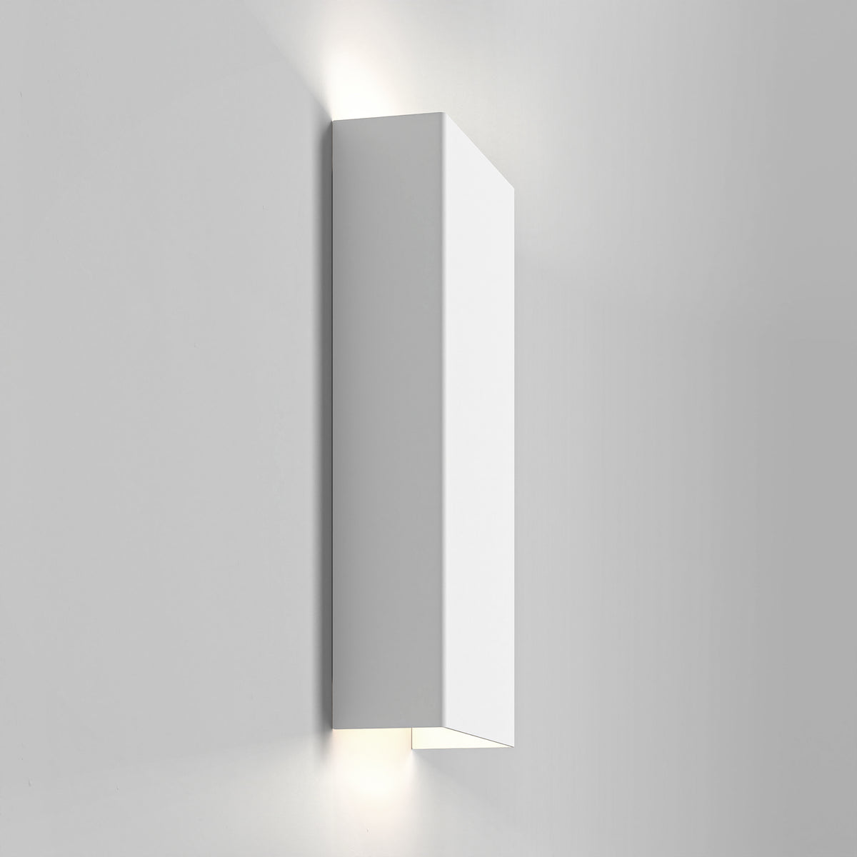 White rectangular wall light fixture with light shining upwards and downwards