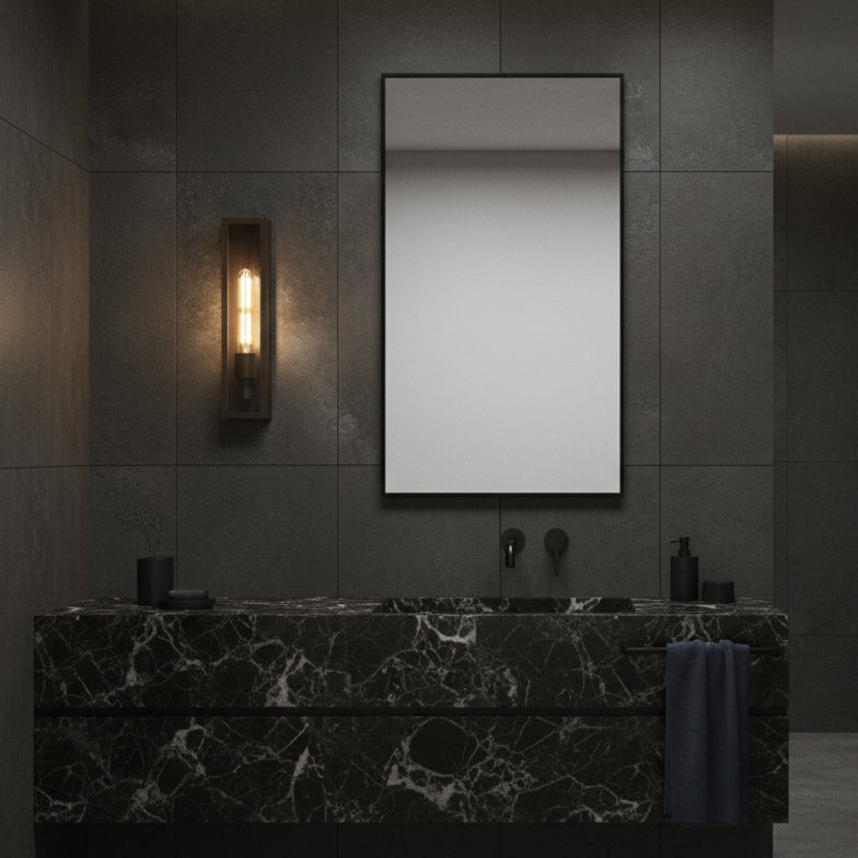 Black marble vanity with a rectangular mirror and a wall-mounted light fixture