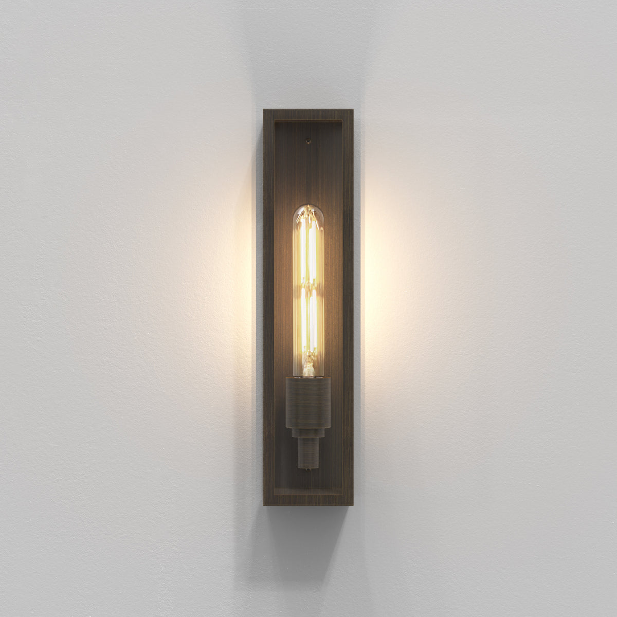 A rectangular wall sconce with a bronze finish and an exposed tubular Edison bulb