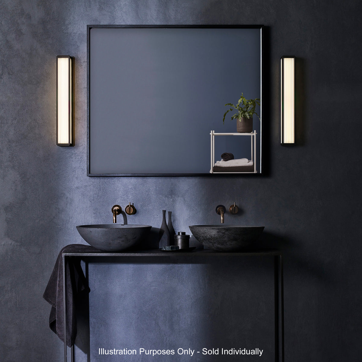 Bathroom with two black sinks, a large mirror, and two vertical wall lights