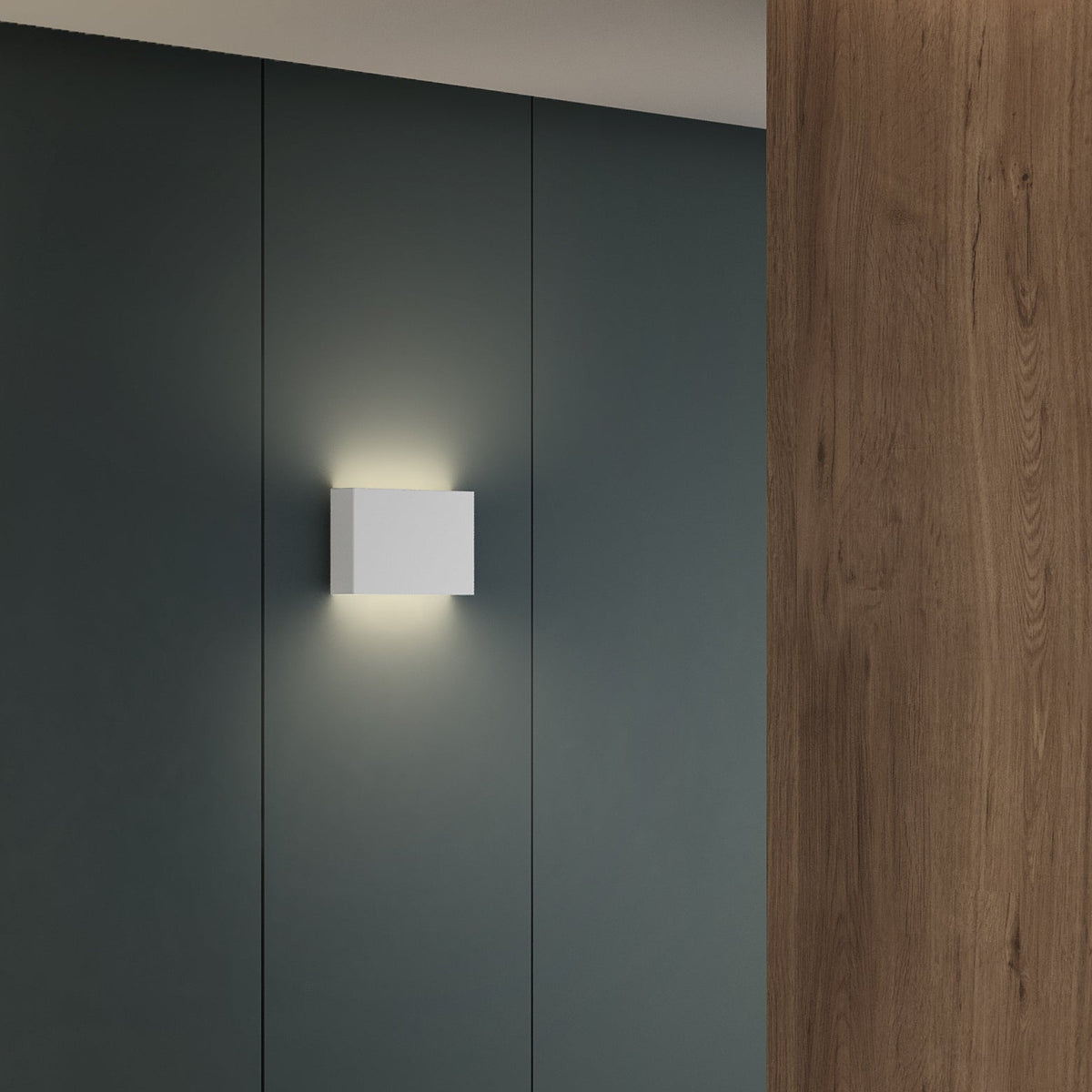 White rectangular wall light on a dark grey wall, with a wooden panel on the right