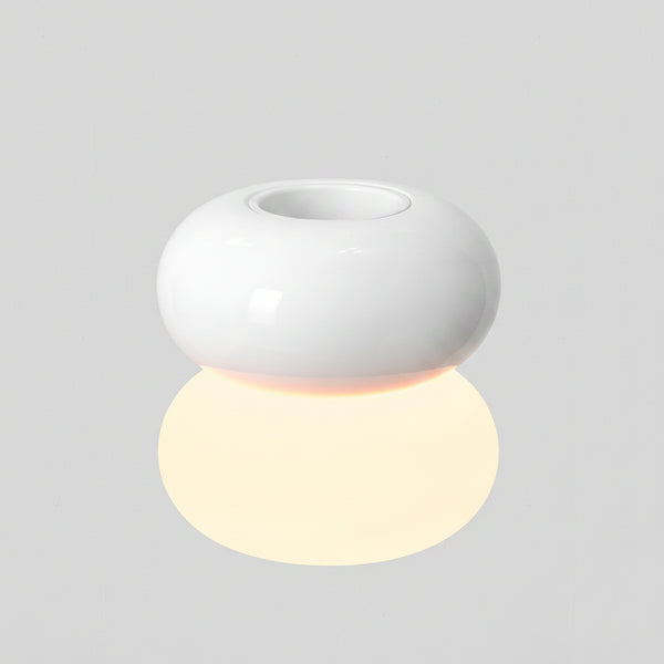 White ceramic diffuser with a glowing spherical light below it