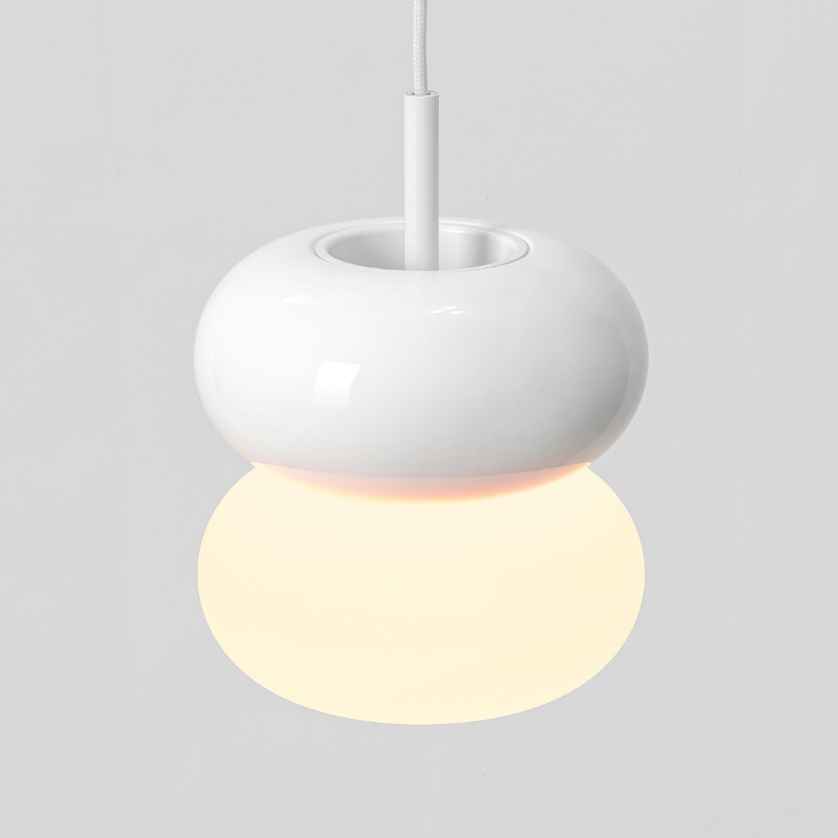White pendant light with a spherical base and a glowing orb